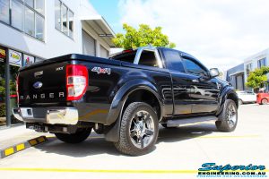 Rear right view of a Ford PXII Ranger in Black before fitment of a Superior 2" Inch Remote Reservoir Lift Kit + Airbag Man Leaf Air Kit