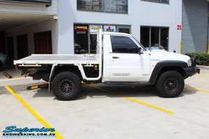 Right side view of a White Nissan GU Patrol Ute before fitting the Superior 4" Inch Remote Reservoir Hyperflex Kit