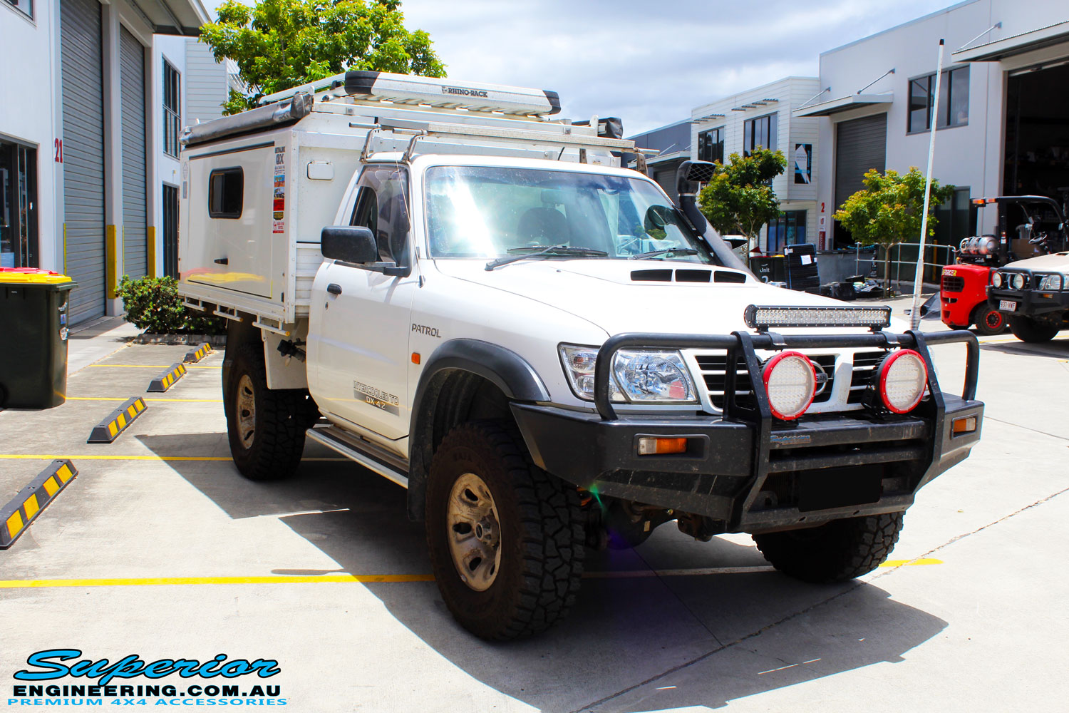 Right front side view of a White Nissan GU Patrol after fitment of a range of Superior and various other brands suspension components