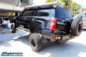 Rear left side view of a Black Nissan GU Patrol Wagon showing its max front right flex before fitting the Superior 2" Inch Remote Reservoir Hyperflex Kit with Front & Rear Superflex Sway Bar Kits, Comp Spec 4340m Tie Rod, Long Arms and Coil Tower Brace Kit