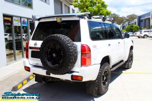 Rear right side view of a Nissan GU Patrol Wagon before fitment of a Superior Remote Reservoir 2" Inch Lift Kit