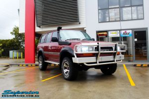 Right front side view of a Toyota 80 Series Landcruiser in Maroon before fitment of a Superior Remote Reservoir Hyperflex 3" Inch Lift Kit