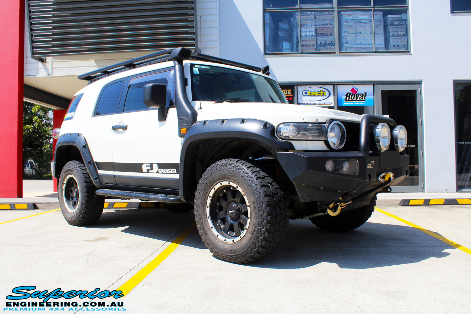 Front right side view of a White Toyota FJ Cruiser after fitment of Superior Chromoly Upper Control Arms