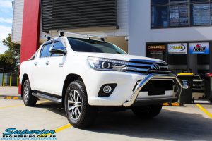 Right front side view of a White Toyota Revo Hilux Dual Cab before fitment of a Bilstein 2" Inch Lift Kit
