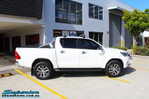 Right side view of a White Toyota Revo Hilux Dual Cab before fitment of a Bilstein 2" Inch Lift Kit