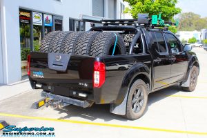 Rear right view of a Black Nissan D40 Navara Dual Cab before fitment of a Superior Nitro Gas 2" Inch Lift Kit + Upper Control Arms