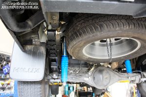 Rear left underbody view of the fitted Superior Remote Reservoir Shocks + Leaf Springs