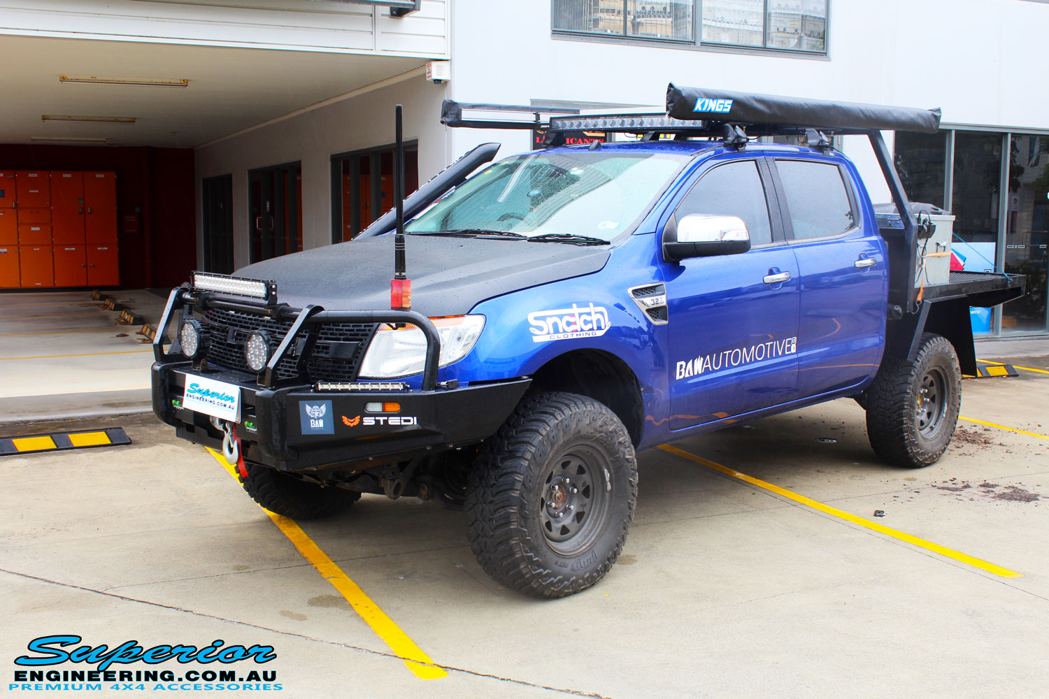 Left front side view of a Ford PX Ranger in Blue after fitment of a Superior 3" Inch Remote Reservoir Lift Kit with King Springs