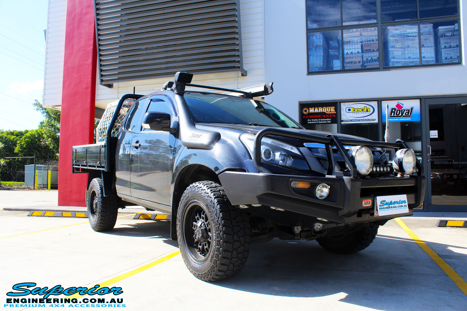 Right front side view of a Black Isuzu D-Max Space Cab being fitted with a Brown Davis Long Range Fuel Tank @ Superior