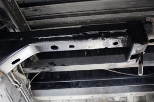 Rear mid under tray shot of a crossmember completed after being repaired