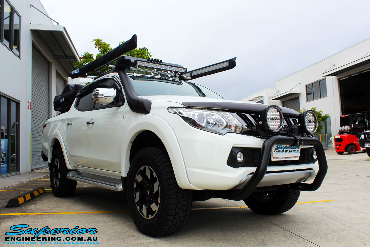 Left front side view of a Mitsubishi MQ Triton Dual Cab after fitment of Superior Nitro Gas Front Struts and Rear Shocks with Front Coil Springs