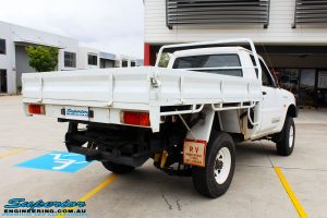 Rear left side shot of this Nissan GU Patrol Ute after fitment of a Superior 4-5 Inch Lift Kit with Superior Remote Reservoir Shocks & Superior Hybrid 5 Link Radius Arms