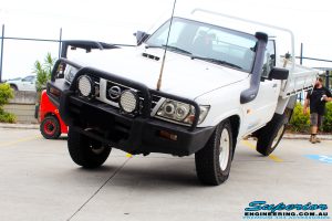 Front left view of this Nissan GU Patrol Ute being flexed from the rear left tyre after fitment of a Superior 4-5 Inch Lift Kit with Superior Remote Reservoir Shocks & Superior Hybrid 5 Link Radius Arms