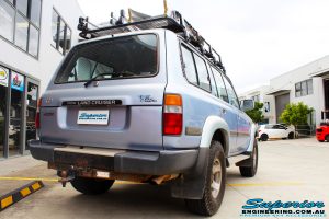Rear right view of a Blue Marlin Toyota 80 Series Landcruiser Wagon after fitment of a Superior Nitro Gas 2" Inch Lift Kit, Superior Radius Arm Rear Bushes & Superior Swaybar Extensions