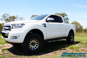 Front left side view of a White Ford PXII Ranger Dual Cab after fitment of a Superior 2" Inch Rear PXII Ranger Coil Conversion Kit with Redarc Dual Battery Setup