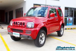Left front side view of a Suzuki Jimny in Red after fitment of a EFS 2" Lift Kit