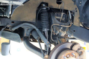 Front left inside guard view of the fitted EFS Shock with Front Torsion Bars