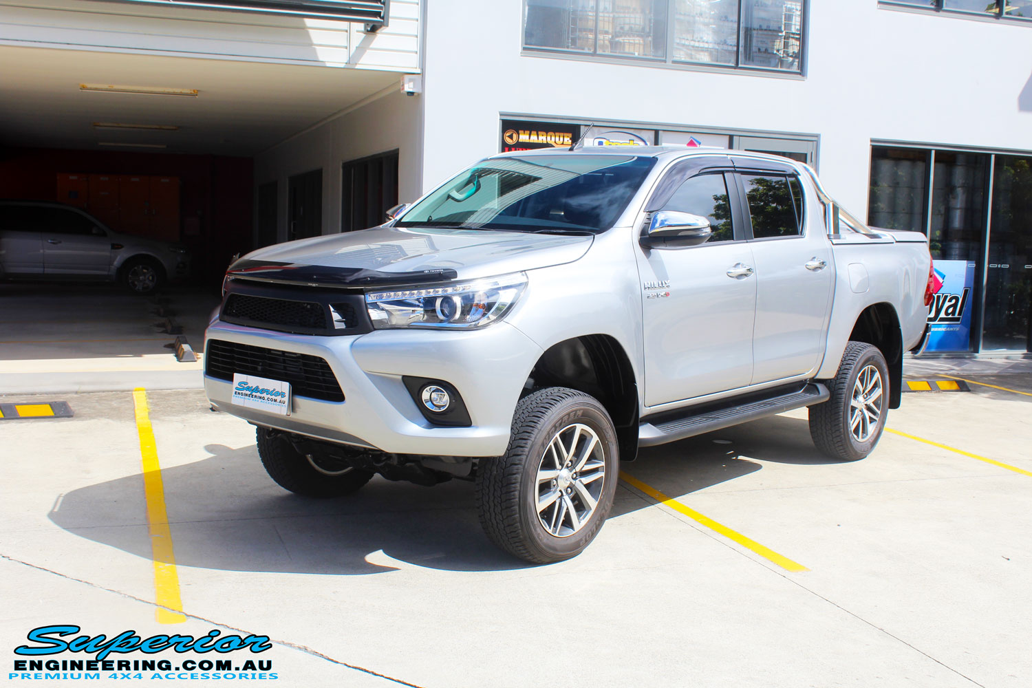 Left front side view of a Toyota Revo Hilux Dual Cab in Silver after fitment of a 3" Inch Lift Kit with King Coil Springs, Superior Billet Alloy Upper Control Arms and Body Lift Kit
